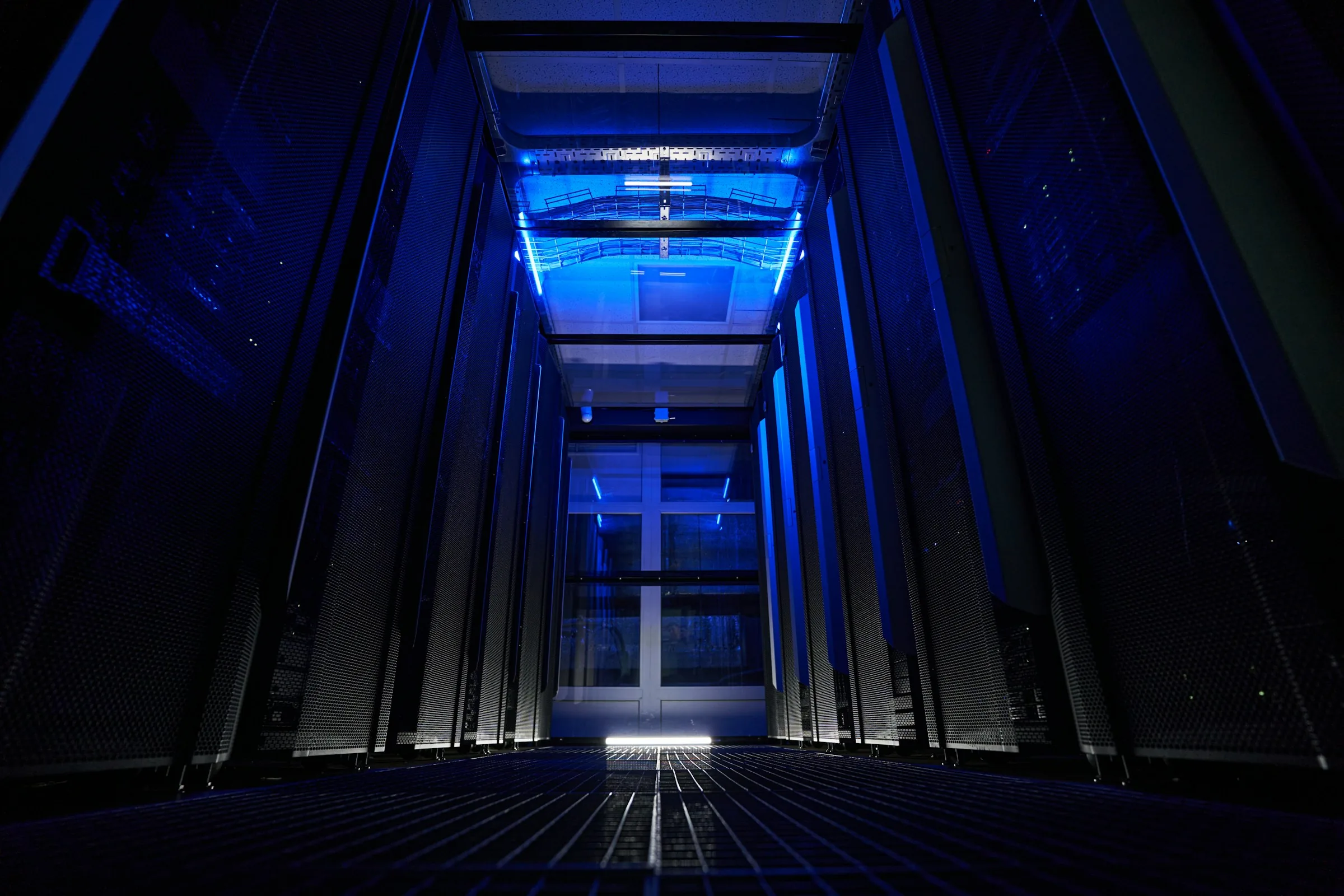 Low angle view of server racks down data center hallway